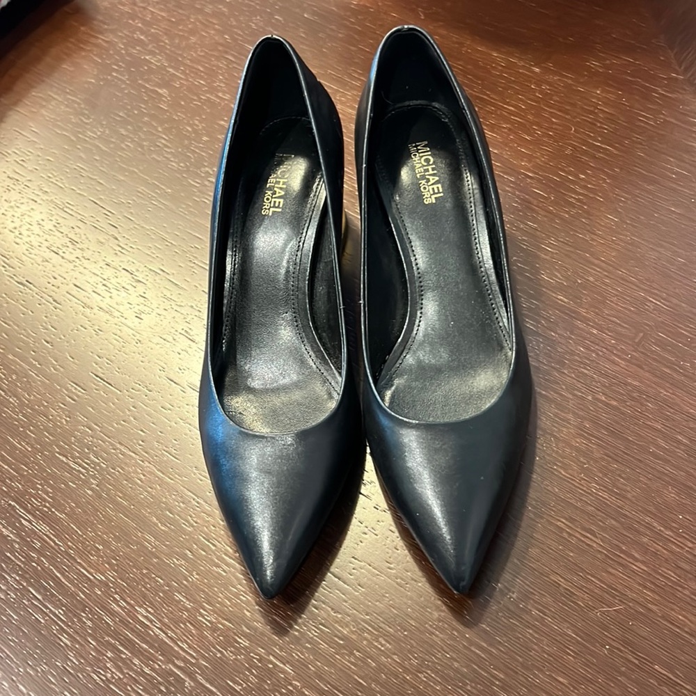 Black Michael Kors shoes with gold heels.
